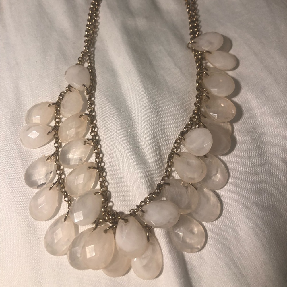 Gold colored chain with white and pink stones
